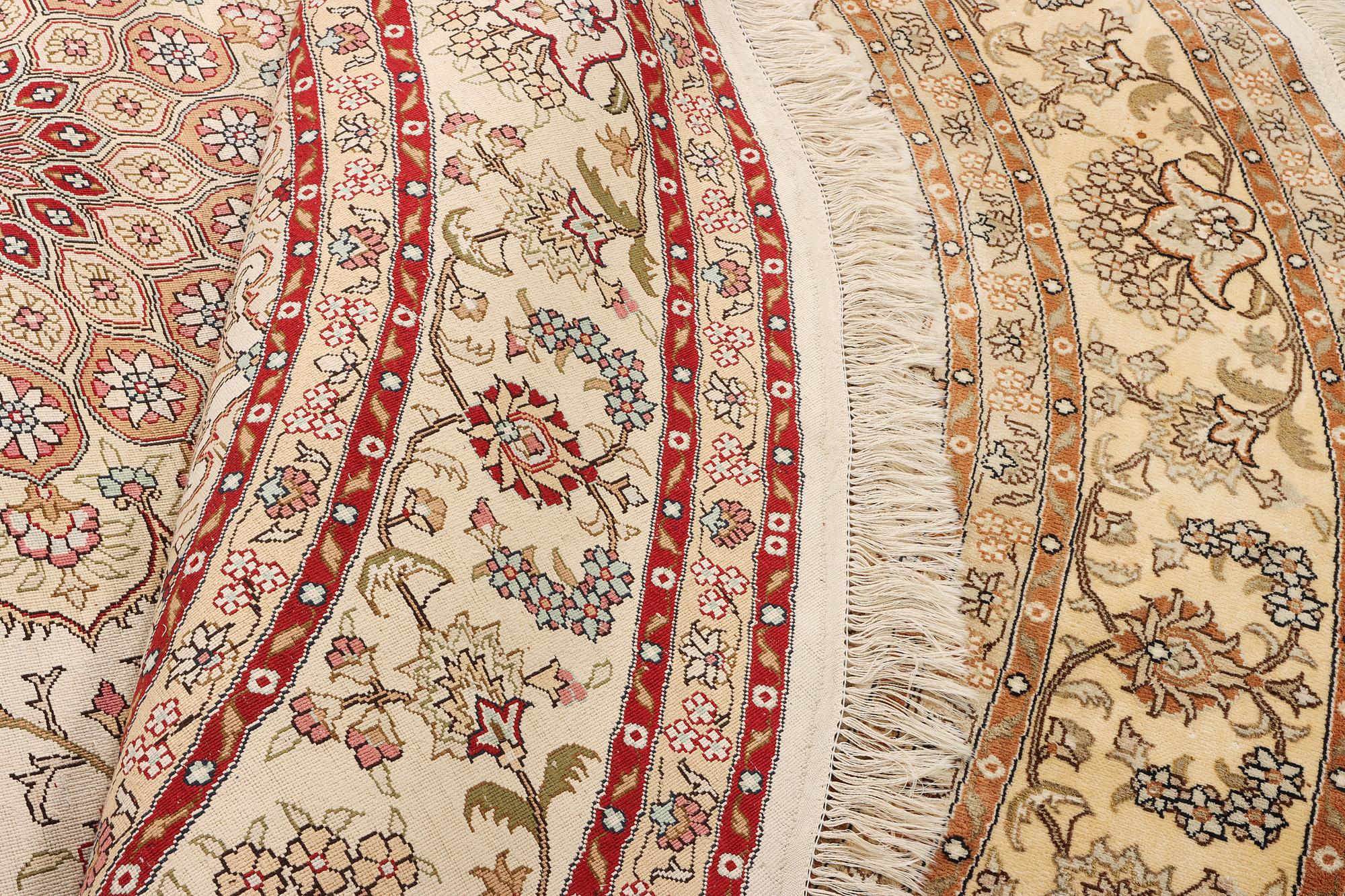 An oriental silk rug, diameter c. 216 cm.