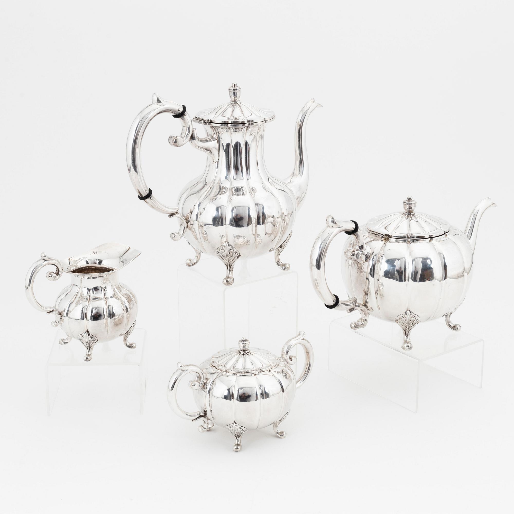 A rococo style sterling silver teapot, coffee pot, creamer and sugar bowl.