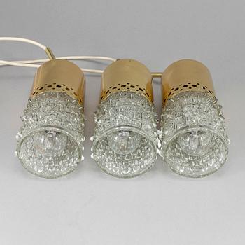 Three brass and glass pendant lights, 1960's.