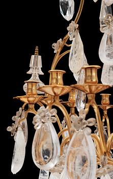 A late Baroque-style circa 1900 rock crystal twelve-light chandelier.