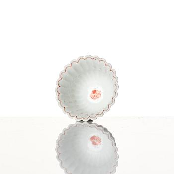 A Chinese iron red porcelain cup with saucer and a small famille verte dish, Qing dynasty, Kangxi (1662-1722).