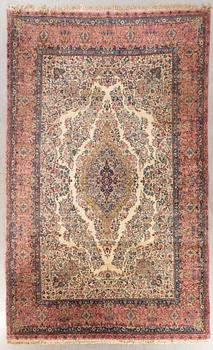 A semiantique Kirman carpet ca 415 x 302 cm.