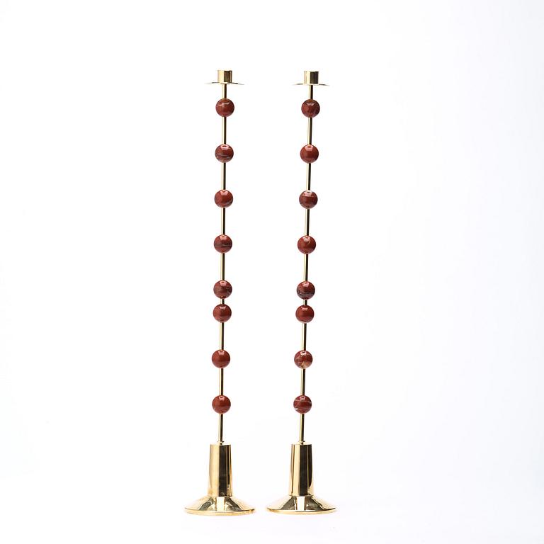 Sigurd Persson, A pair of brass and red jasper candlesticks, Uno Berg AB, Sweden.