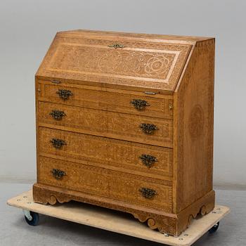 A carved oak secretaire, 19th Century.