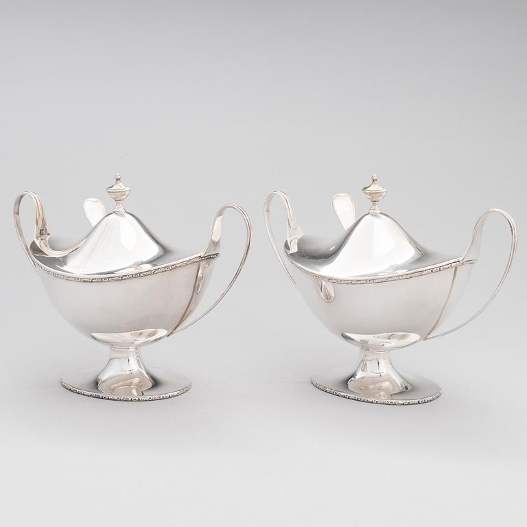 A pair of lidded silver sugar bowls with sprinkle spoons, mark of The Firm Carl Fredrik Carlman, Stockholm 1928-29.