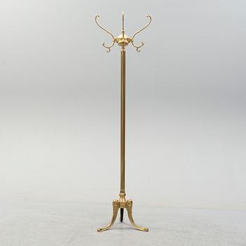 a brass coat hanger from the late 20th century.