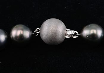 A NECKLACE, tahitian pearls 10 - 13 mm. Clasp in 14K white gold. Length 45 cm.