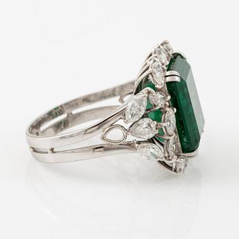 An 18K white gold ring set with a step-cut emerald.