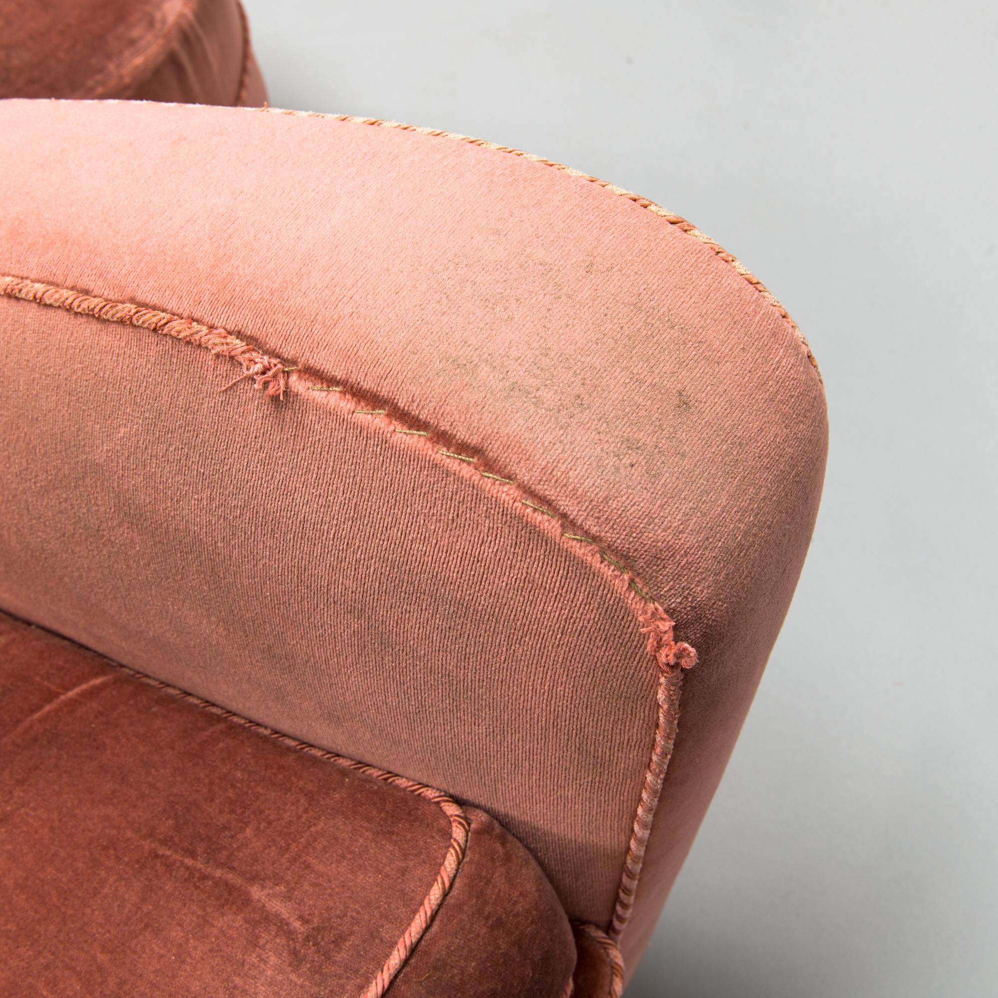 A mid-20th century armchair and ottoman.