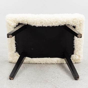 A mid 20th Century stool with sheepskin upholstery.