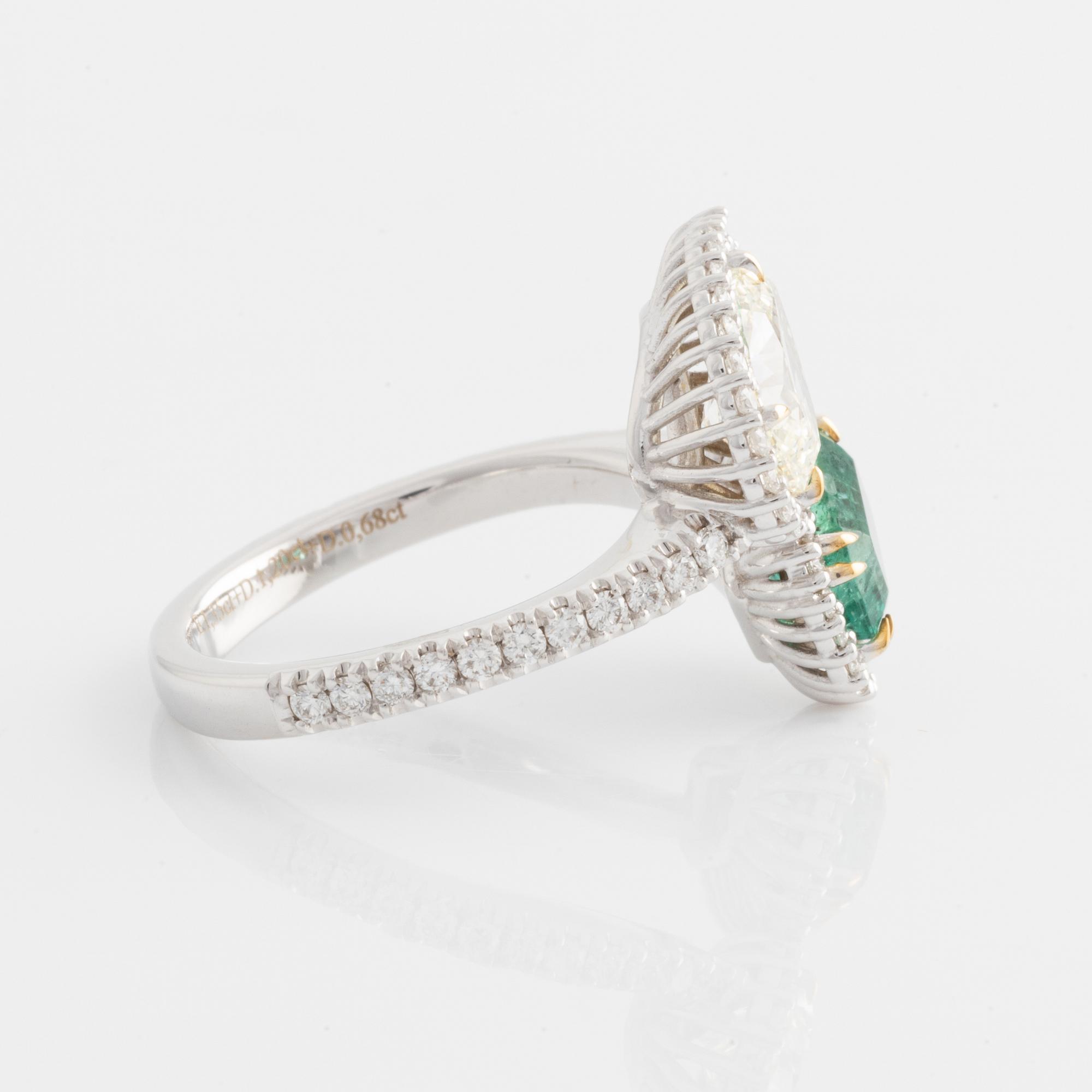 Ring with emerald-cut emerald and pear-shaped diamond, accompanying GIA diamond report.