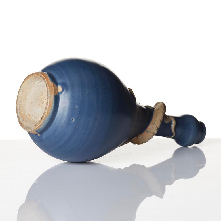 A blue glazed vase with a dragon in relief, late Ming dynasty/early Qing dynasty.