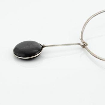 Vivianna Torun Bülow-Hübe, a pendant with chain, silver with a beach pebble, 1963.