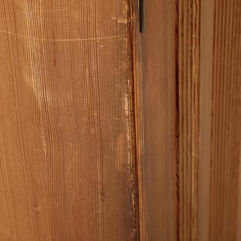 A pair of pine cupboards with shelves by Carl Malmsten.