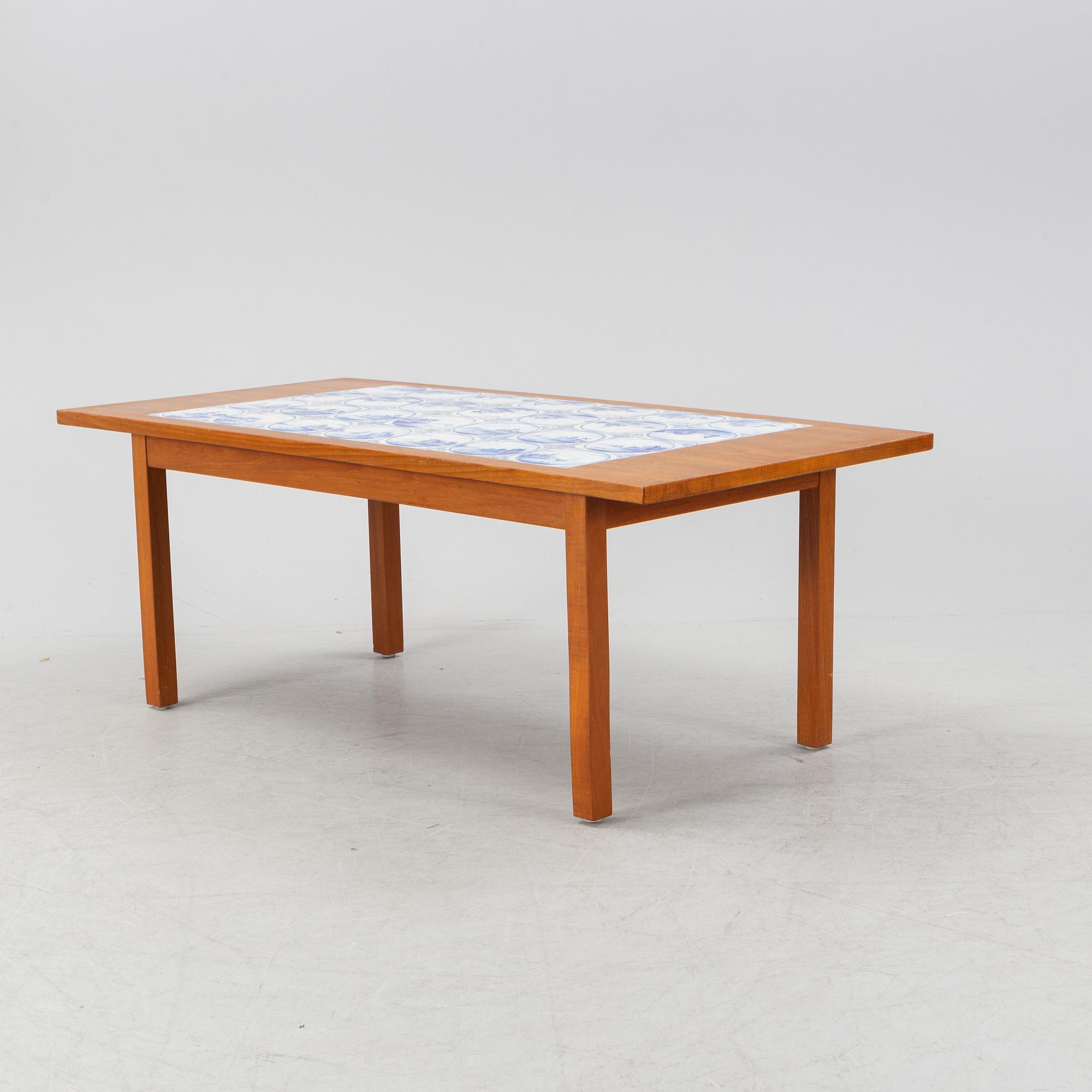 A teak coffee table with inlaid tiles. Second half of the 20th Century.