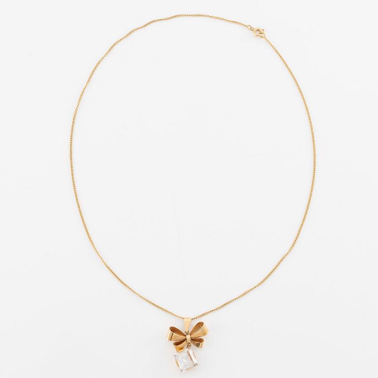 Necklace, 18K gold with synthetic white stone, in the shape of a bow.