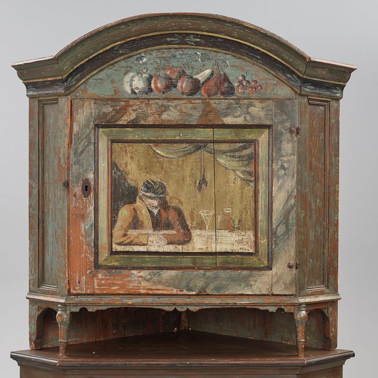 A Swedish polychrome-painted corner cabinet attributed to J. Bäckström (1773-1837).