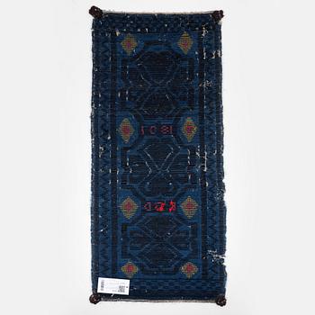 A carrige cushion, knotted pile in relief, ca 46,5 x 101 cm probably Bara district, Scania, Seeden.
