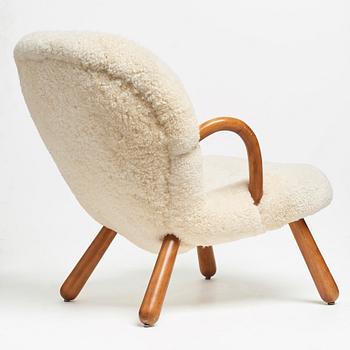 Philip Arctander, attributed to, a Clam Chair re-upholstered in white sheepskin, executed or sold by Vik & Blindheim Norway.