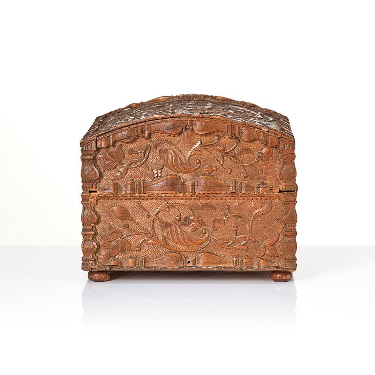 A baroque wedding casket, carved wood, dated 1725.