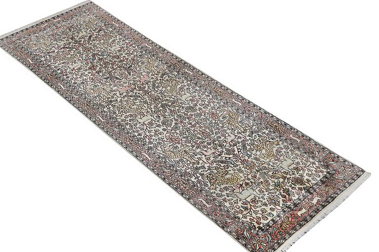 A carpet, silk Kashmir, c. 300 x 92 cm.