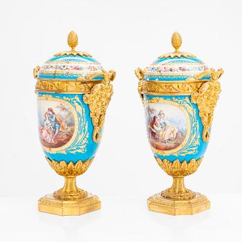 A pair of French porcelain urns from around the turn of the 20th century.