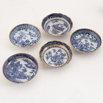 A set of nine gilt and blue and white cups with saucers, Qing dynasty, Qianlong (1736-95).