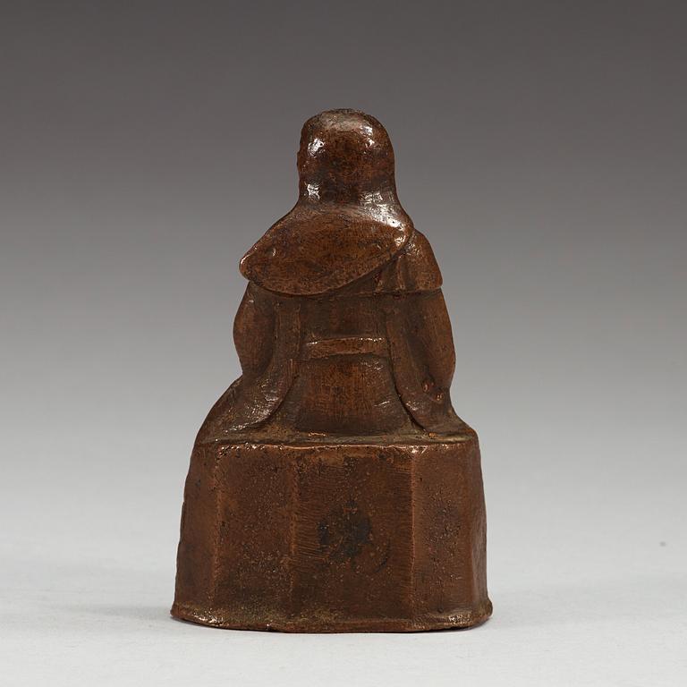 A seated copper-alloy figure of a the God of War, Guan Di, Ming dynasty (1368-1644).