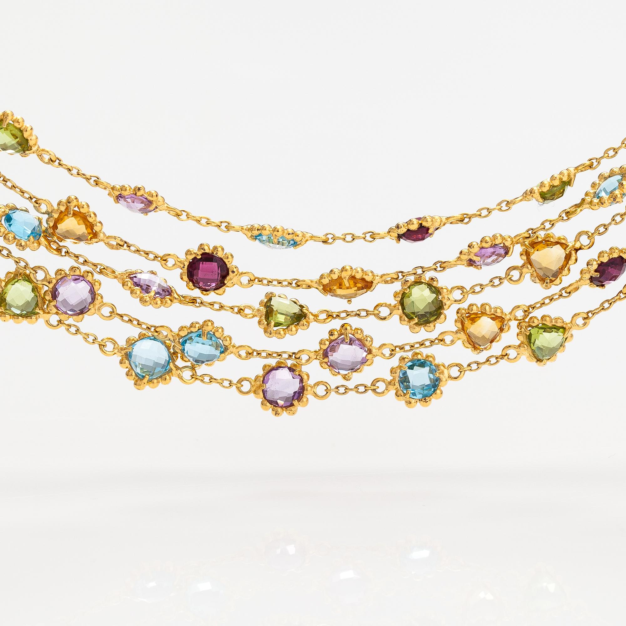 A gilded silver bracelet with topazes, garnets, peridotes, amethysts and quartzes.