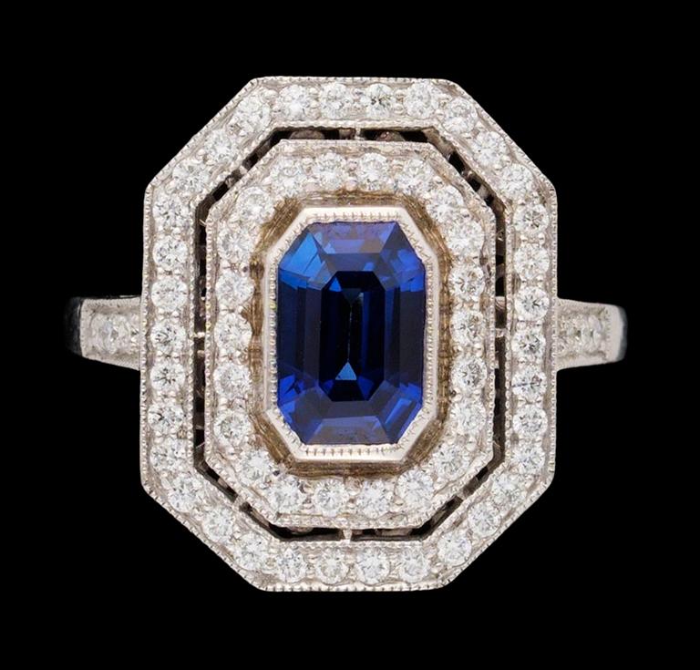 A gold blue sapphire and diamond ring.