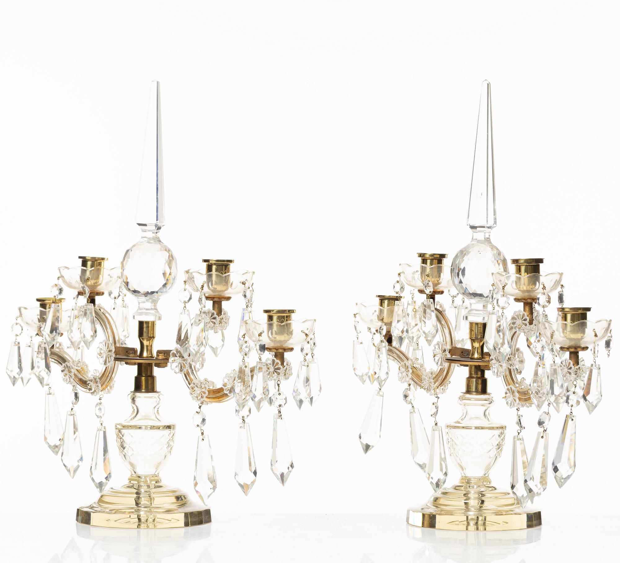 A pair of brass and glass canelabras, first half of the 20th century.