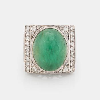 An 18K white gold ring set with a cabochon-cut emerald and round- and eight-cut diamonds.