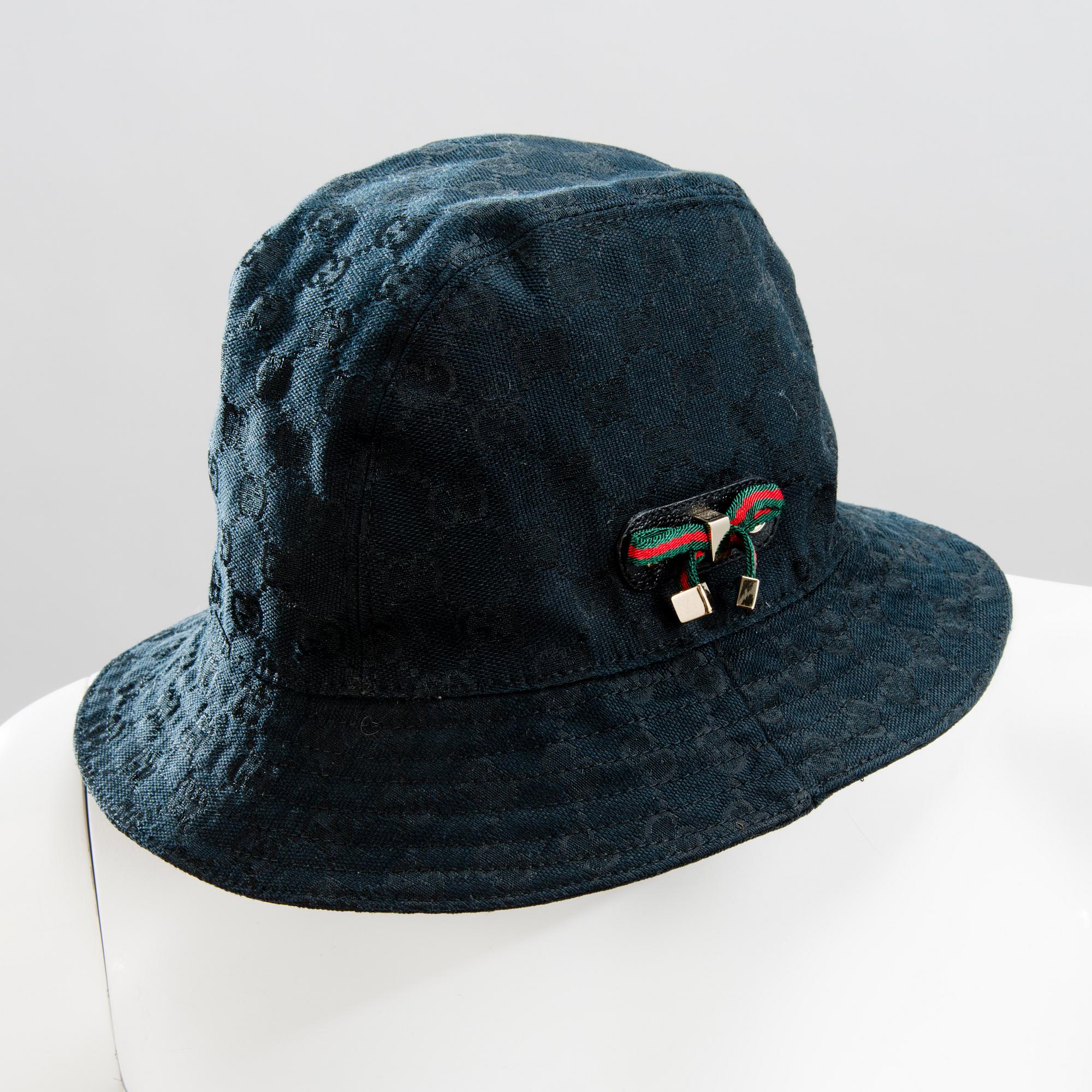 GUCCI, CAMEL HAIR PONCHO AND A HAT.