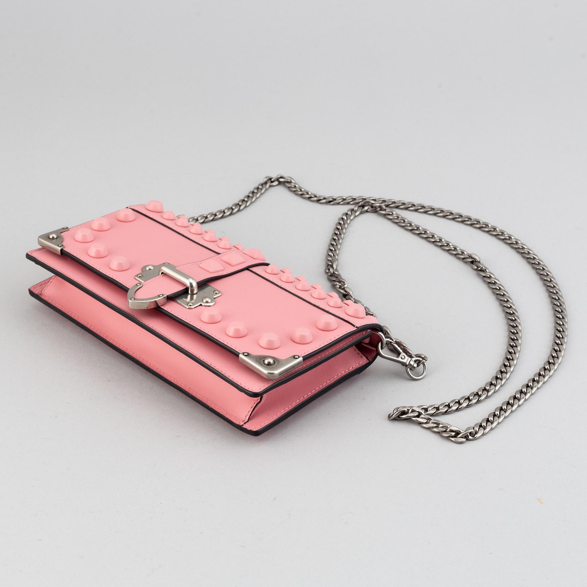 A Prada leather mini bag " Cahier" with metal details and rivets. Marked "Prada Milano". Authenticity card included.