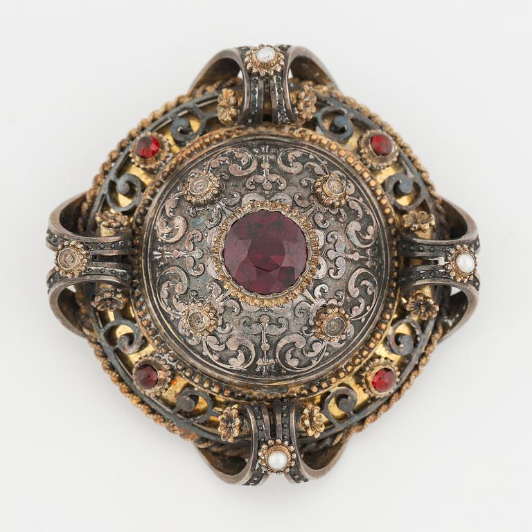 Silver and garnet brooch.