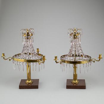 A pair of late Gustavian style three-light candelabra.