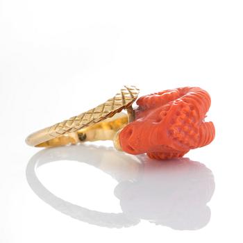 A ring in carved coral in the form of a ram's head.