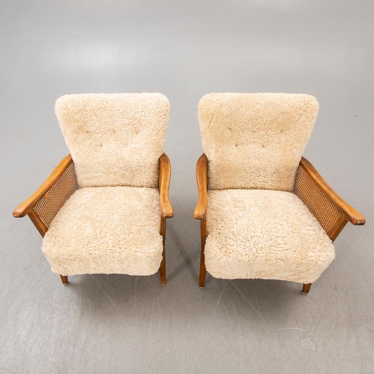 A pair of 1940/50s cheep skin armchairs.