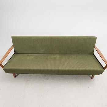 A 1960s teak sofa bed.