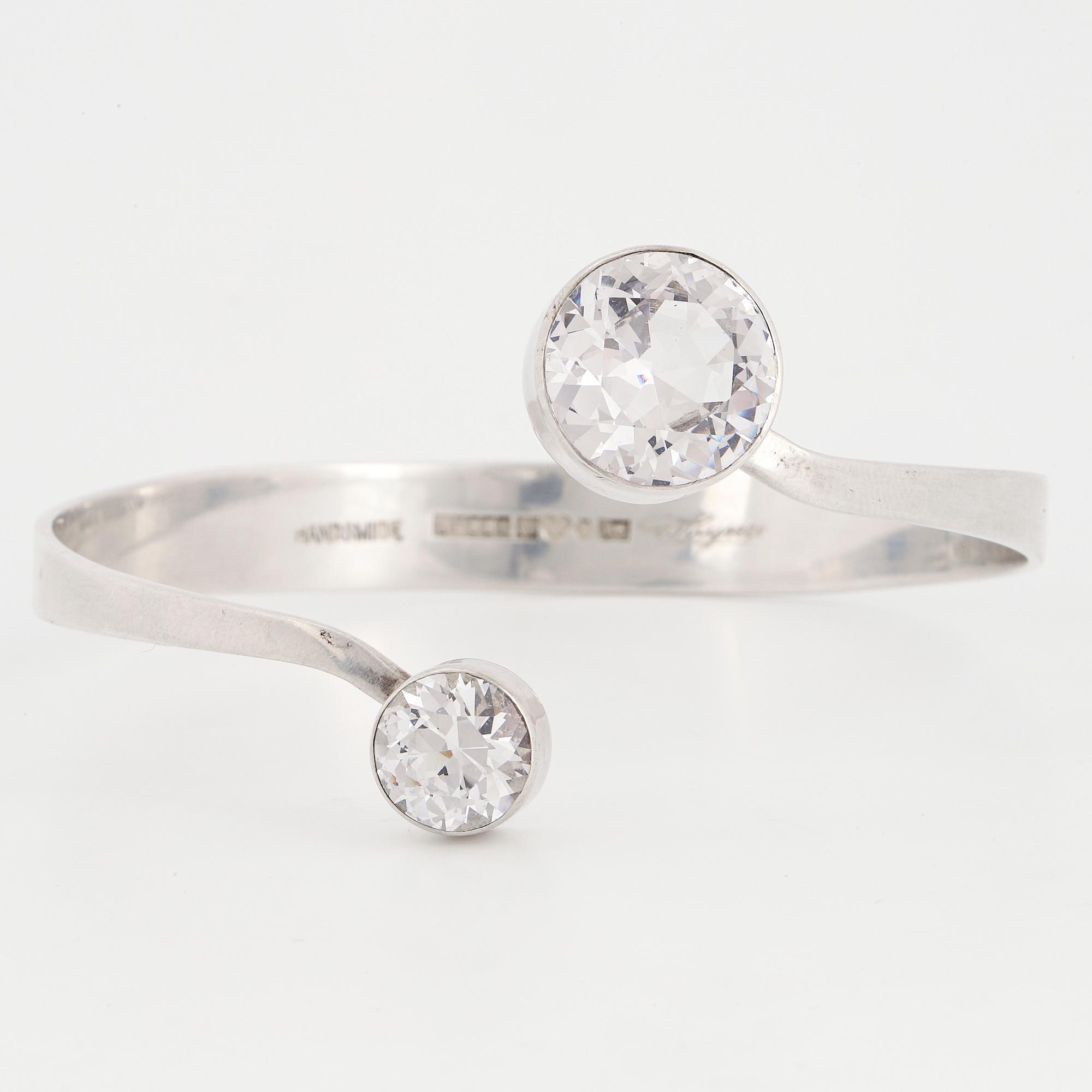GERT THYSELL, a silver and synthetic white spinel bangle, Gussi, Malmö, 1973.