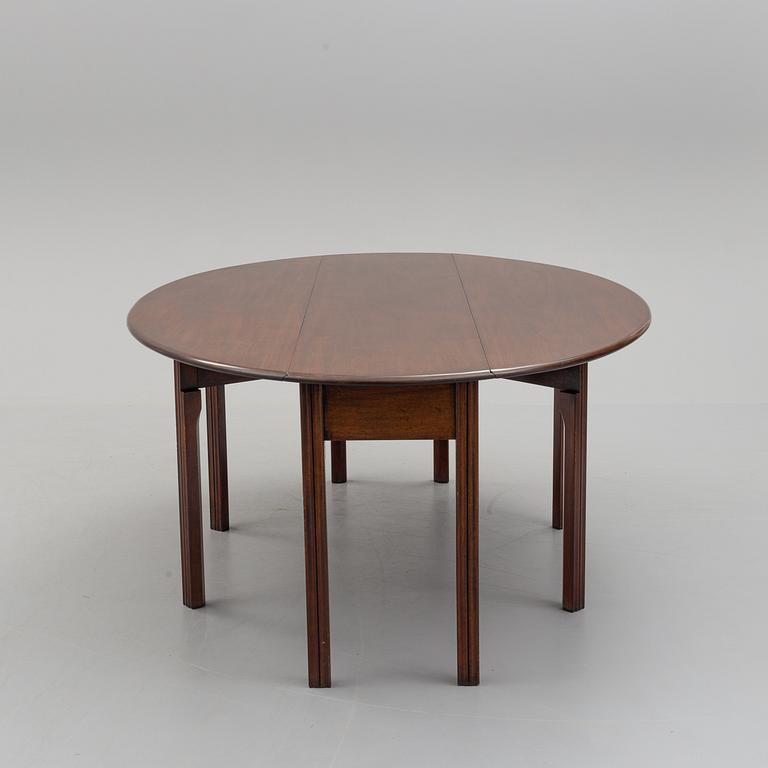 A DINING TABLE, England, made for NK, Nordiska Kompaniet, Sweden. Signed with label. Probably 1960s / 70s.