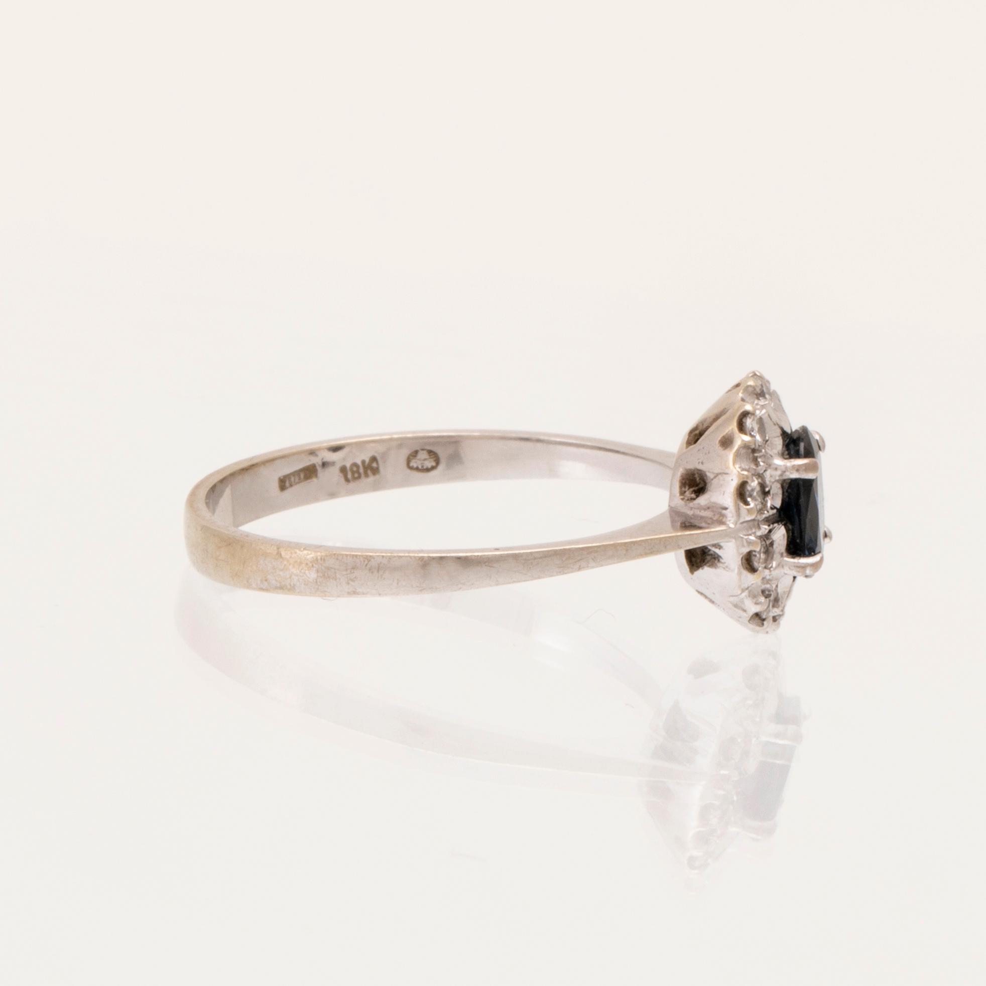 An 18K white gold carmosé ring set with an oval faceted sapphire and round brilliant-cut diamonds, Alessandria Italy.