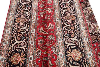 A Tabriz carpet, part silk, 50 raj, c. 325 x 208 cm.