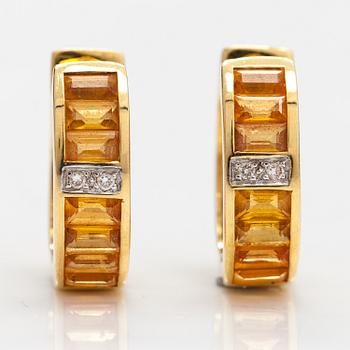 A pair of 18K gold earrings with yellow sapphires and ca 0.01 ct of diamonds.