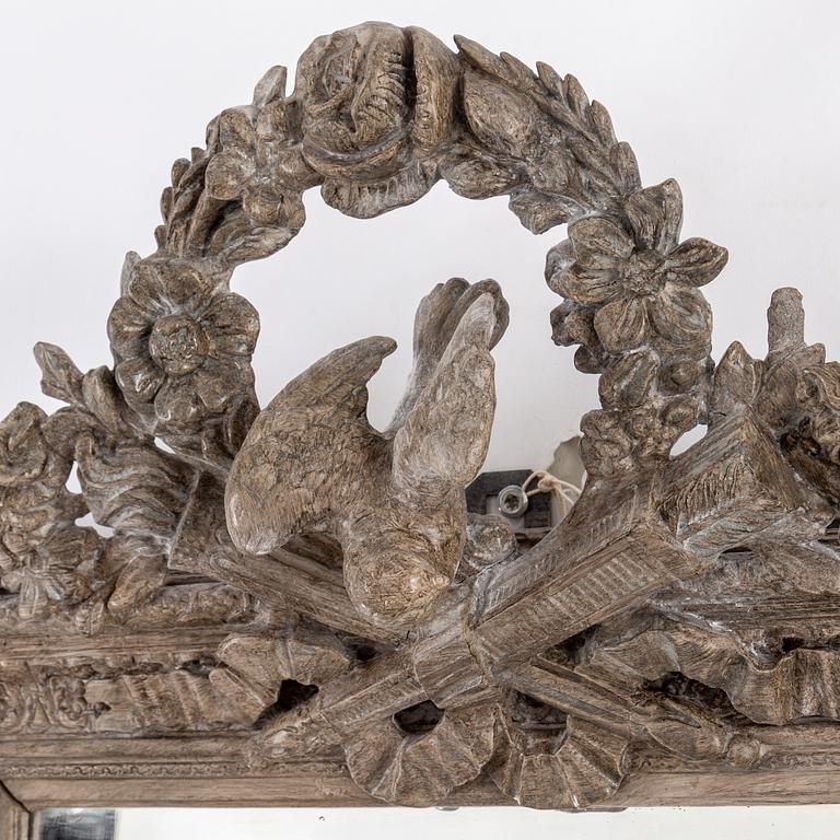 A carved wooden framed mirror, circa 1900.