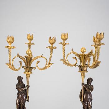 A pair of 19h Century Louis XVI style three-light candelabra in bronze and marble.