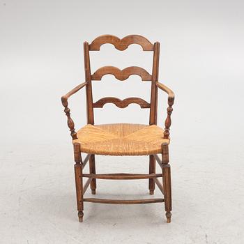 A French walnut open armchair, first part 19th century.