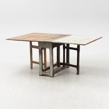 A 18th century gate-legged pine table.
