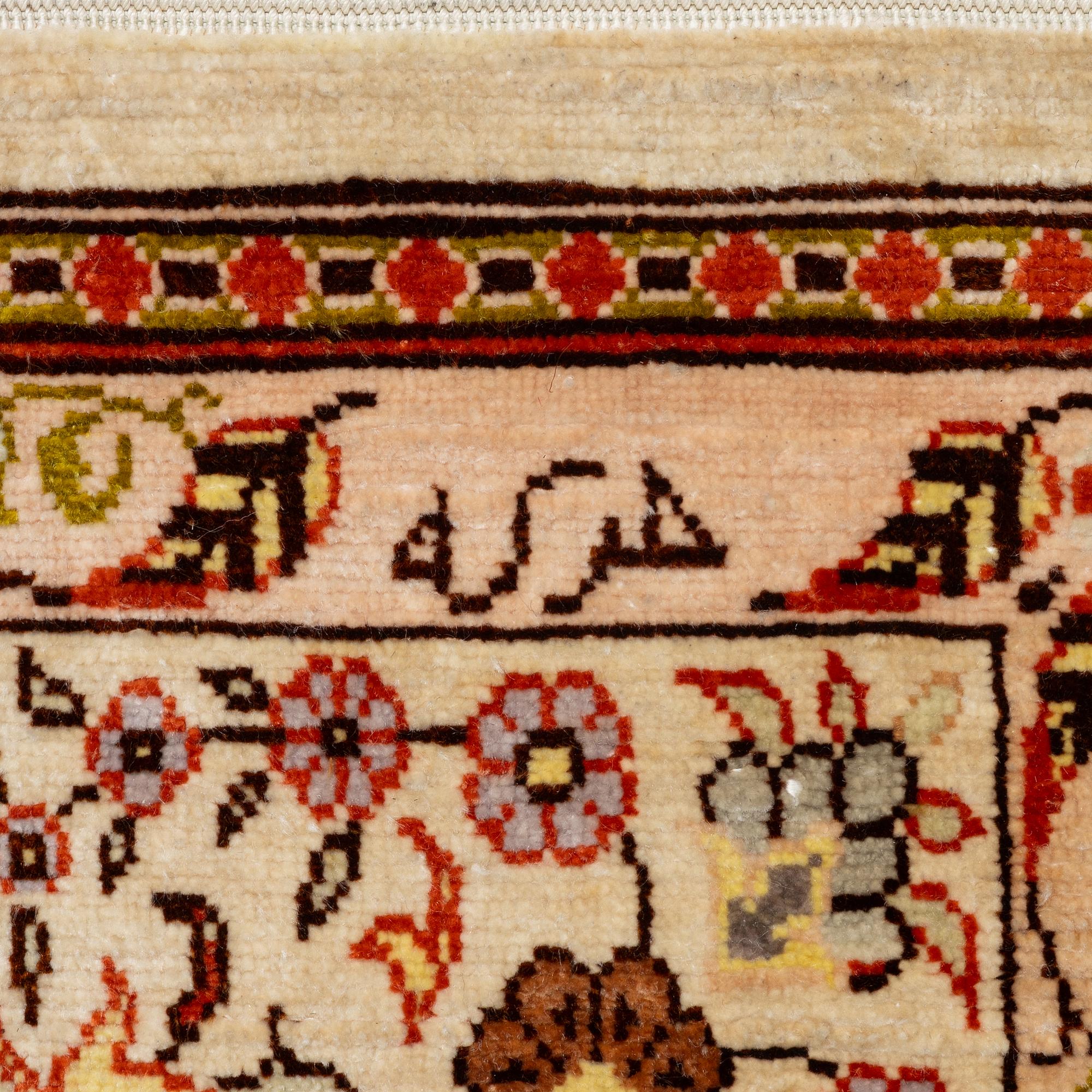 A Hereke silk rug, West Anatolia, c. 107 x 69 cm.