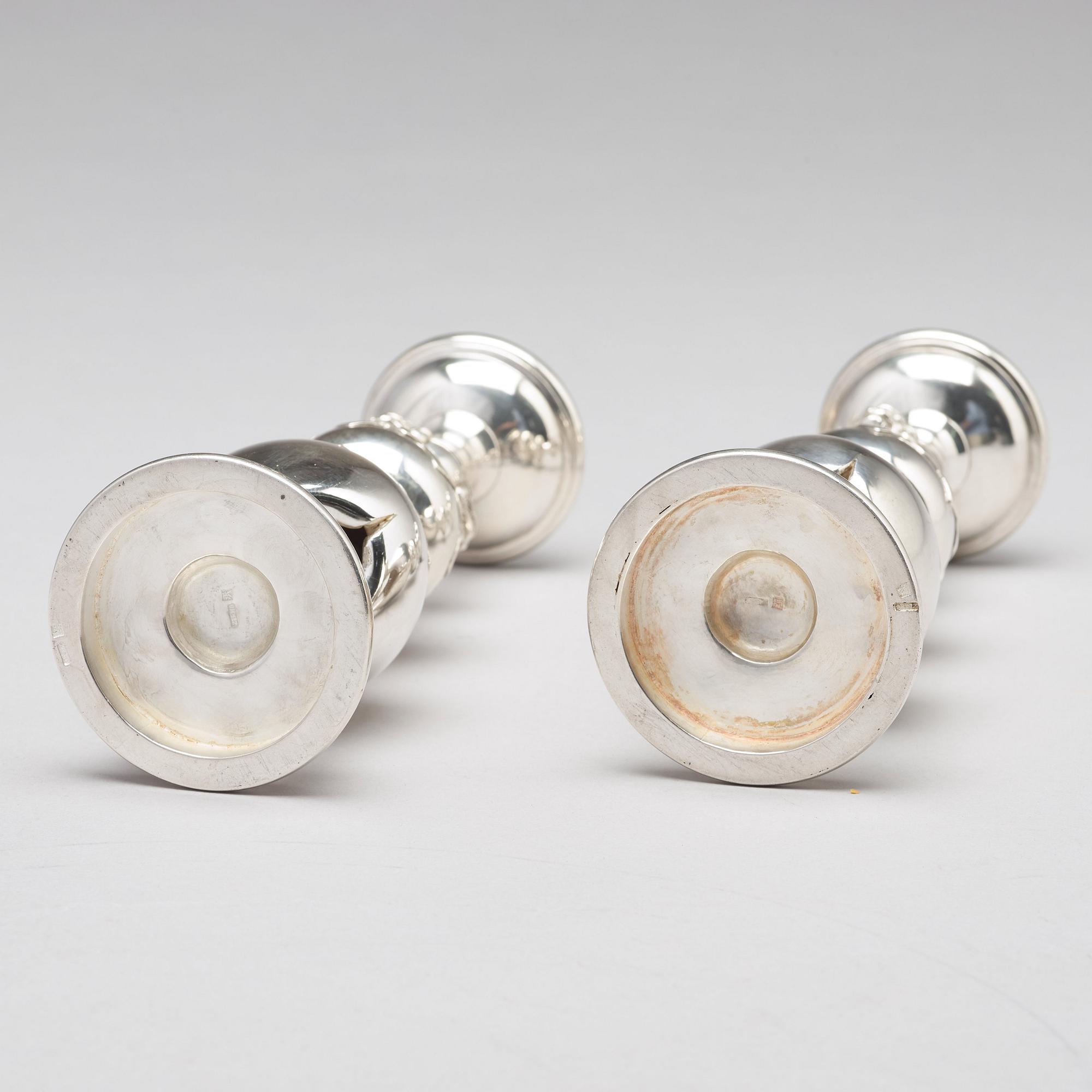 A pair of Chinese silver candle sticks, Shanghai, early 20th Century.